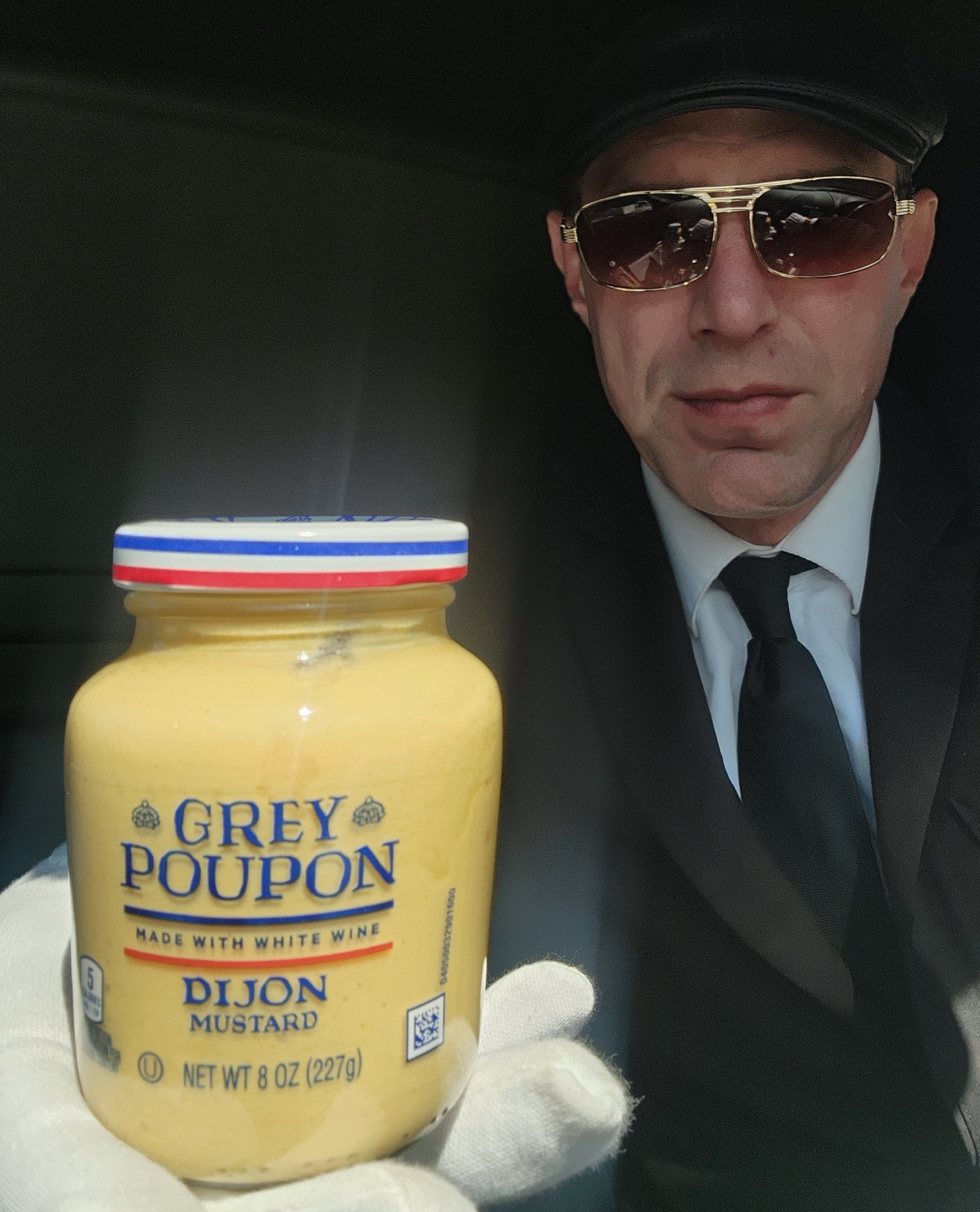Chauffeur with Grey Poupon — a playful nod to classic limo service