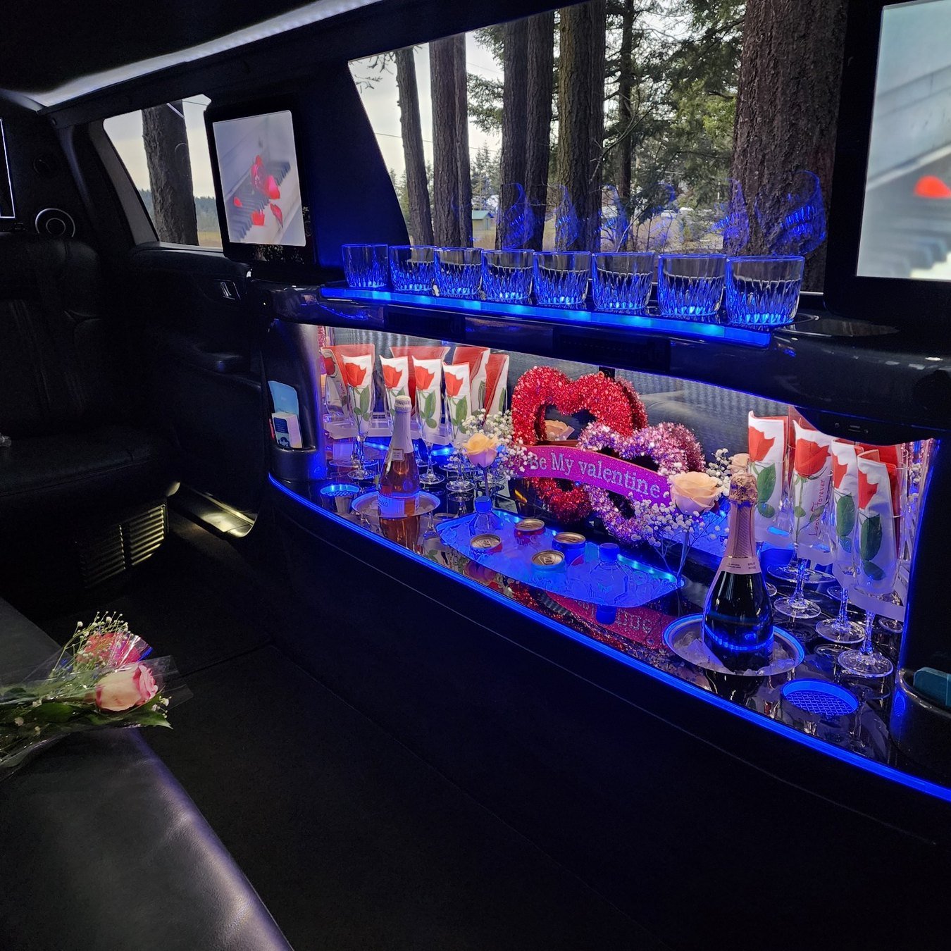 Valentines Day stretch limousine interior decorated with roses and romantic lighting