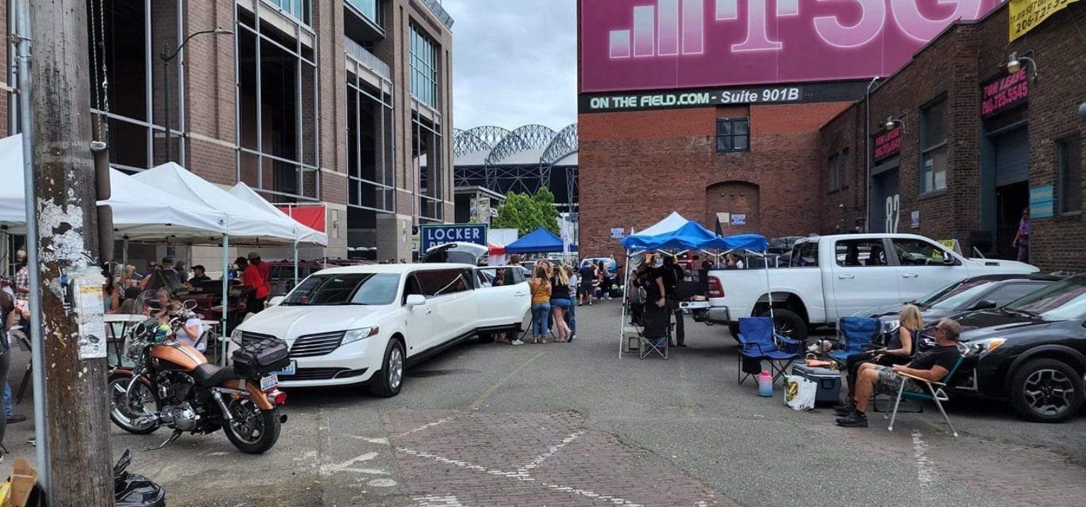 White stretch limousine staged near Lumen Field in Seattle for a concert event
